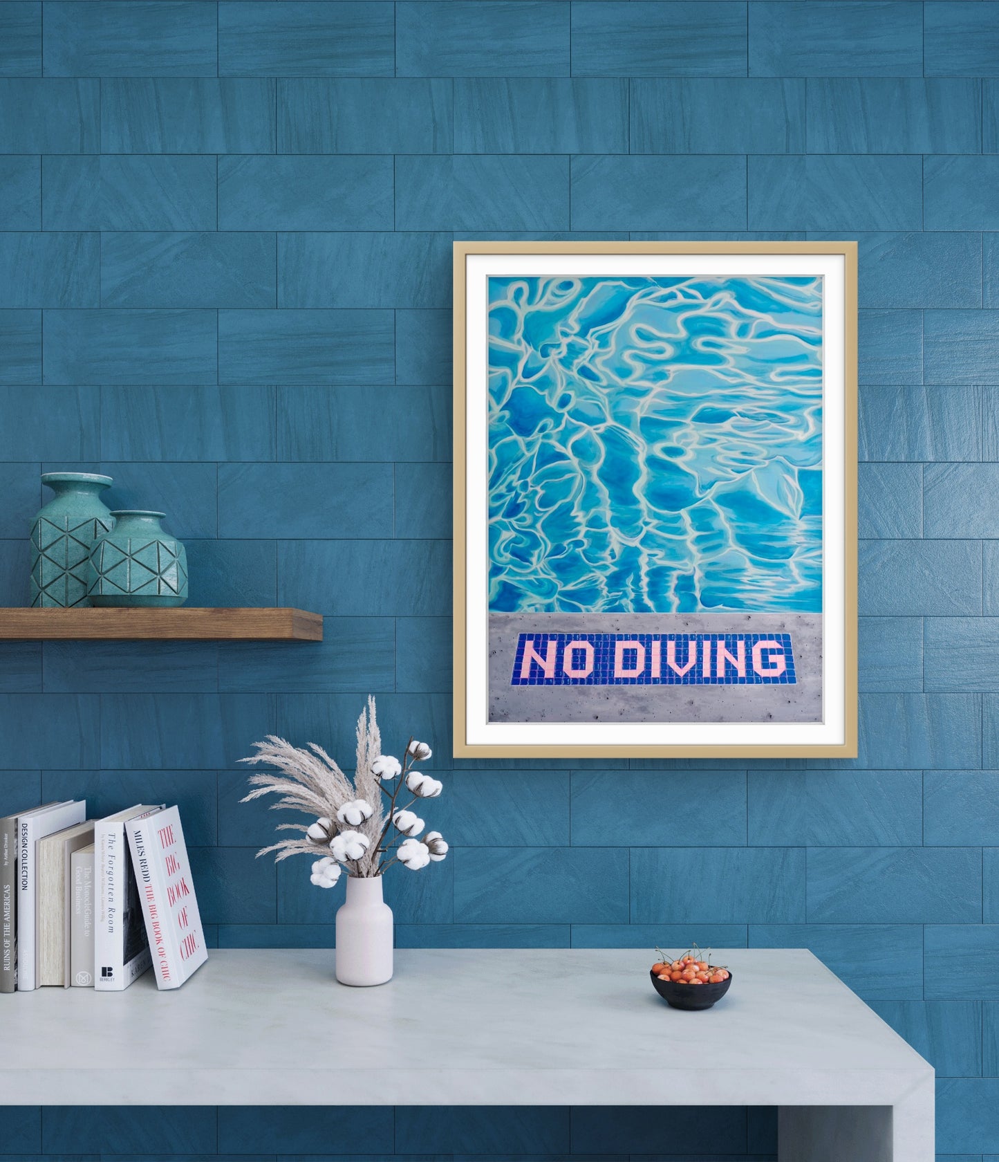 Framed artwork with 'No Diving' sign on a blue wall with decorative items below.