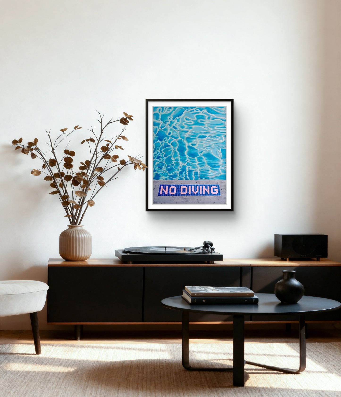 Framed 'No Diving' poster on a wall above a turntable in a living room.