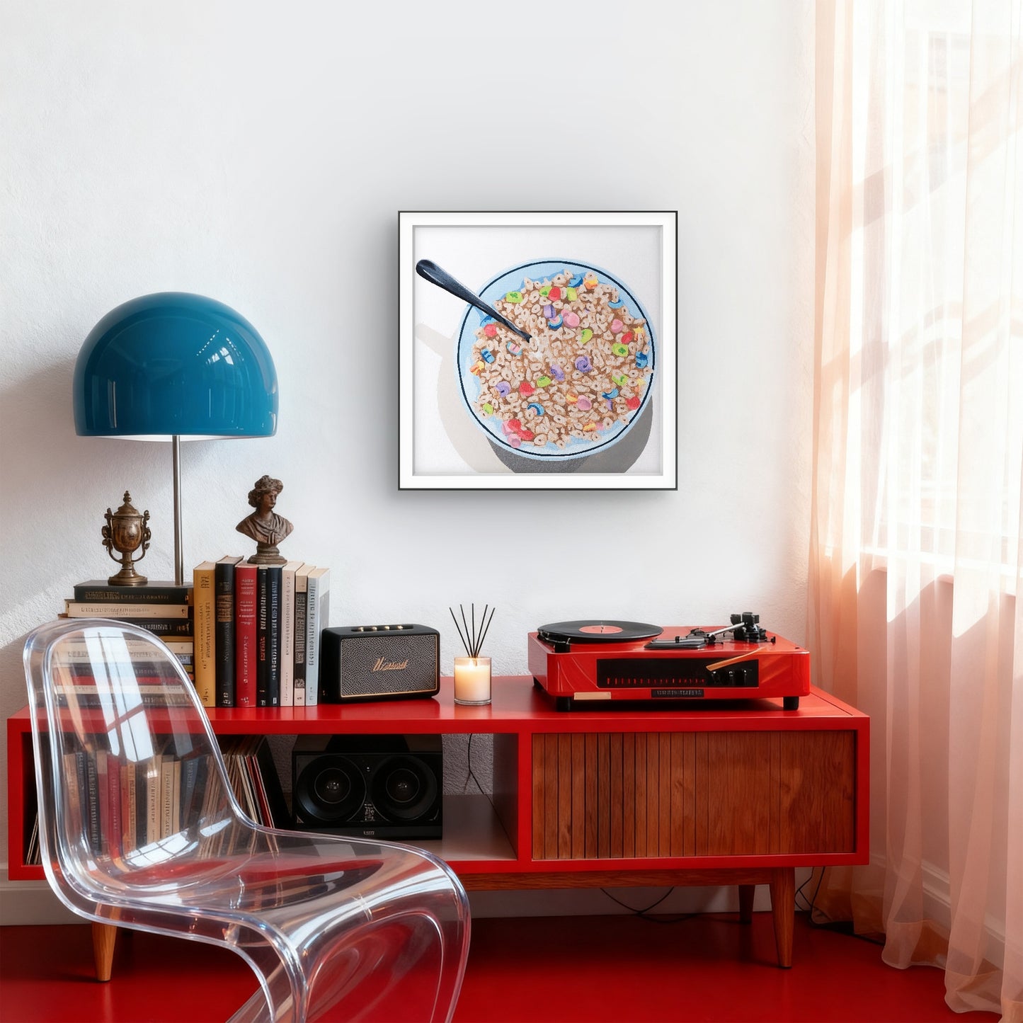 Modern interior with red console table, clear chair, blue lamp, and framed picture of cereal bowl.