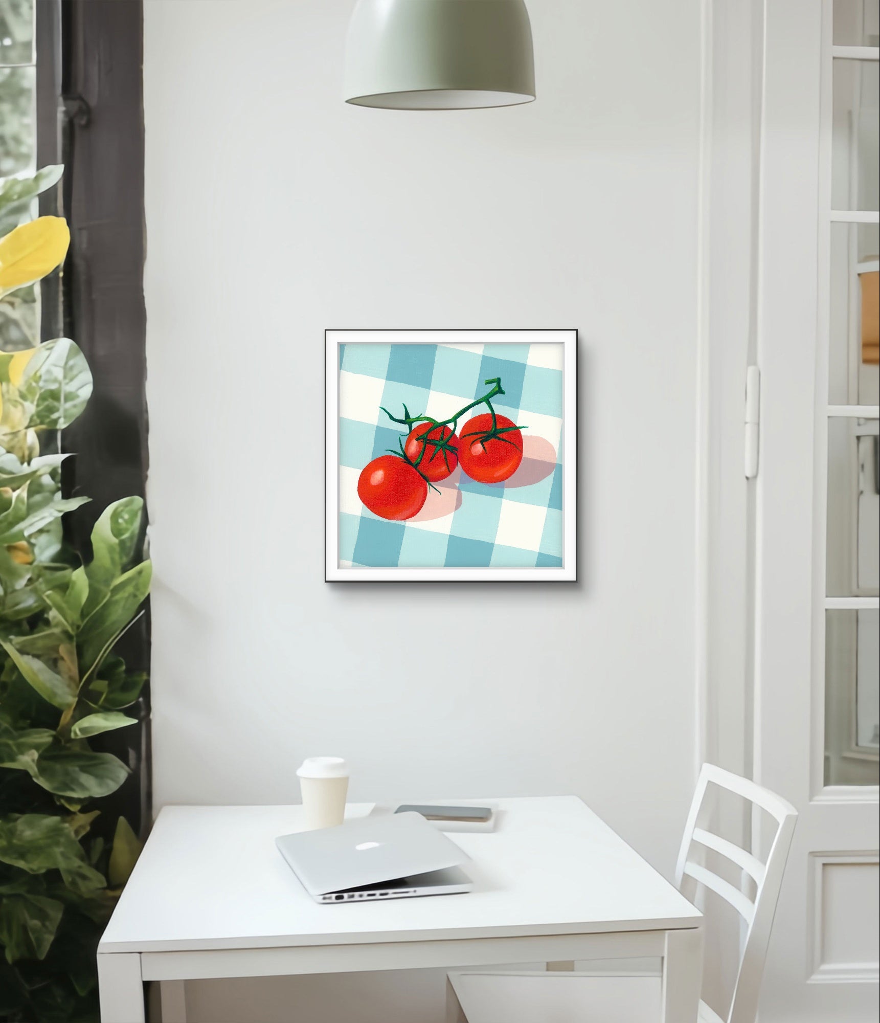 Framed artwork of tomatoes on a checkered background in a modern office setting.