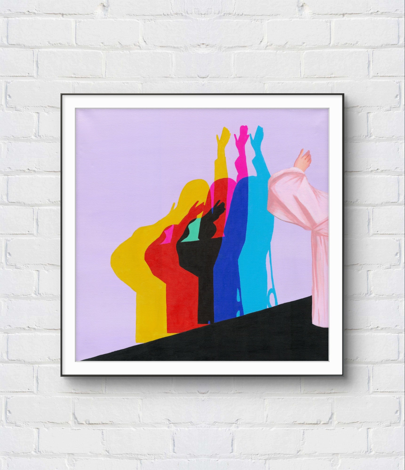 Framed abstract art with colorful figures on a white brick wall