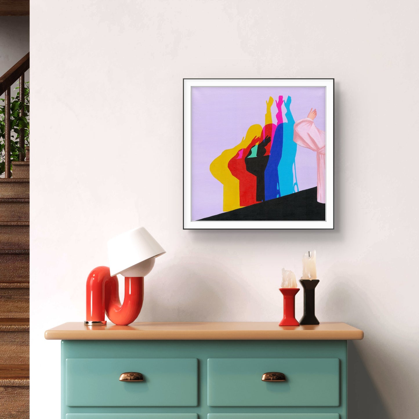 Colorful abstract art on a wall above a wooden dresser with decorative items.