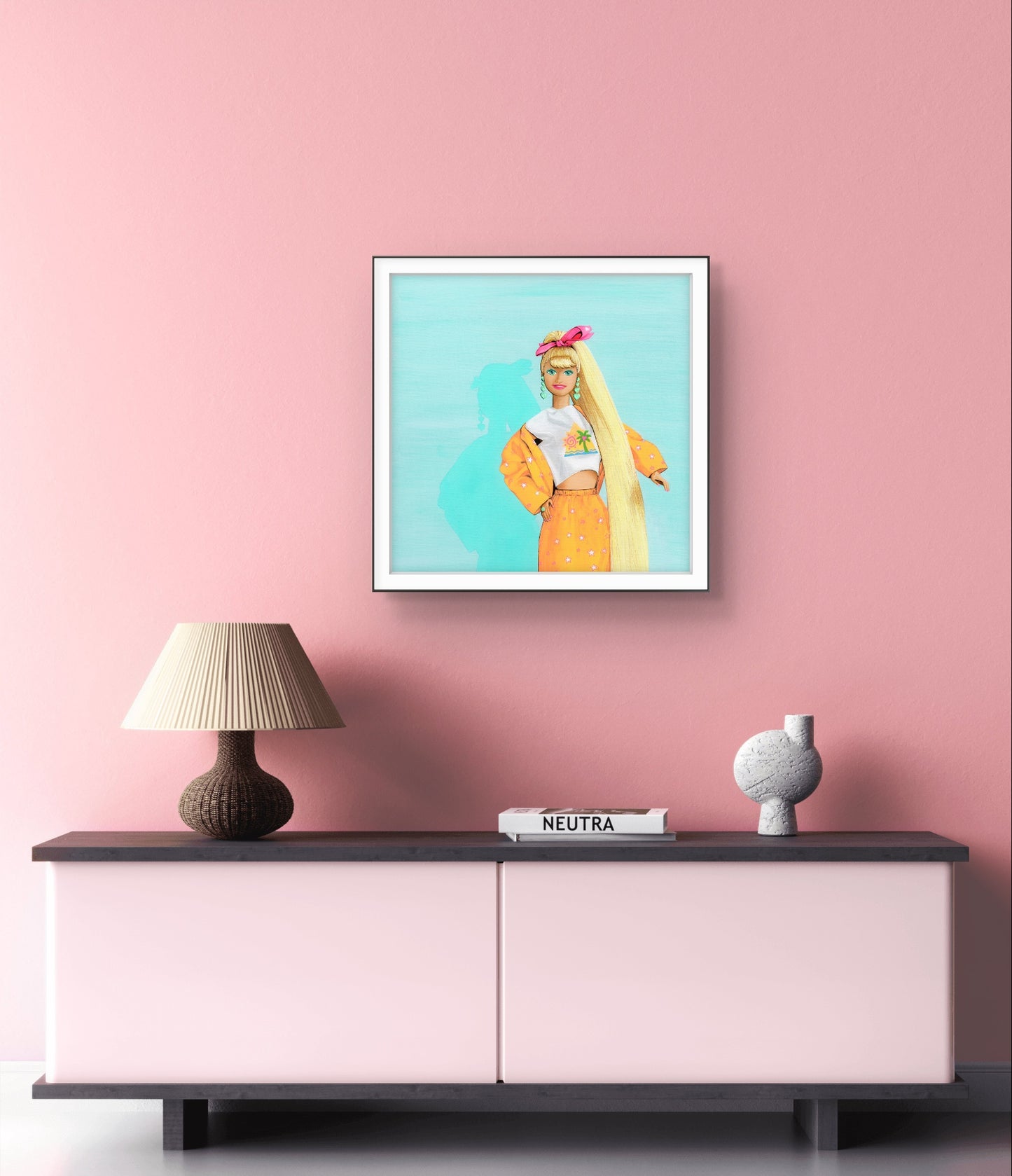 Framed artwork of a woman with long blonde hair on a pink wall above a sideboard.
