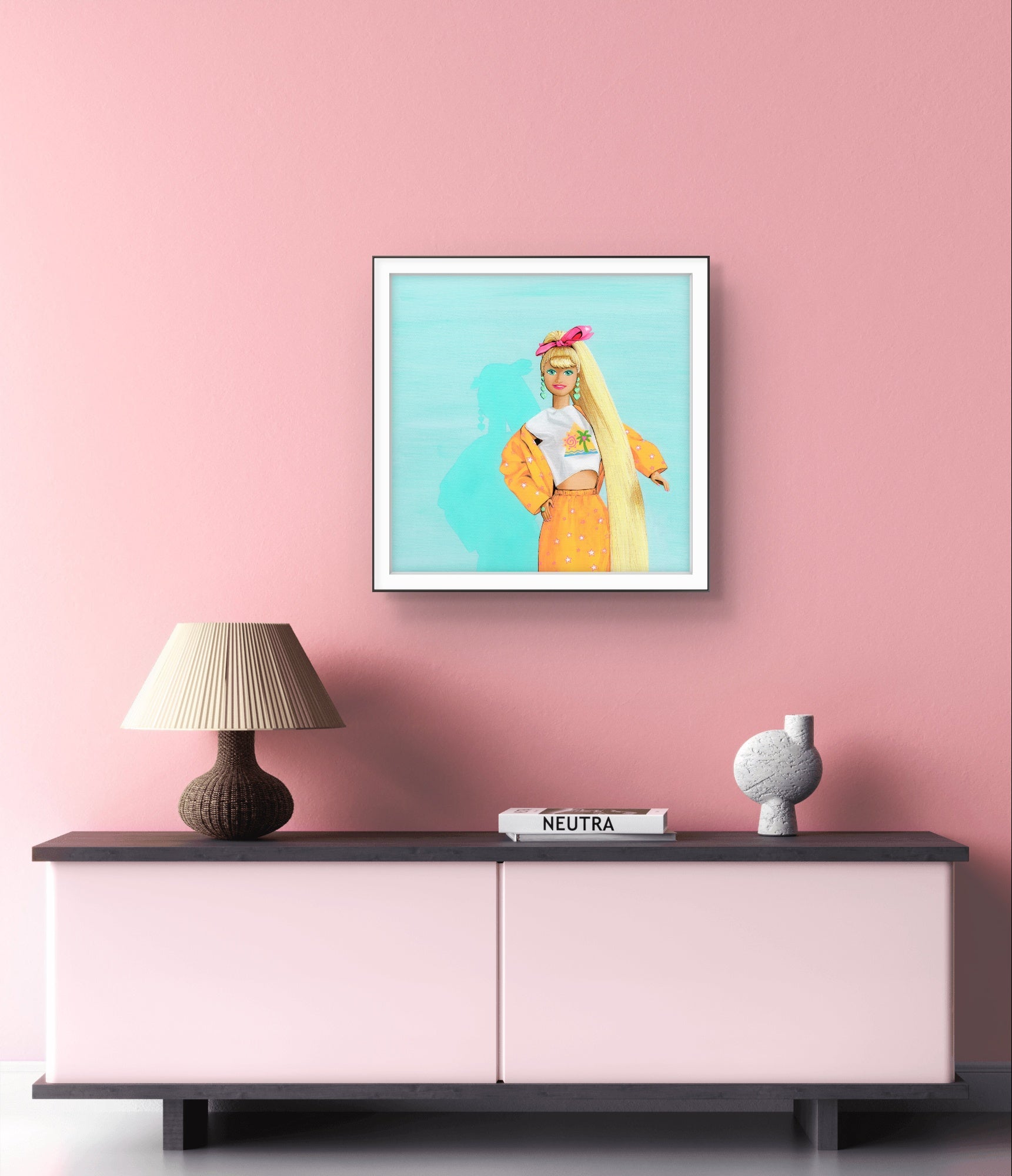 Framed artwork of a woman with long blonde hair on a pink wall above a sideboard.