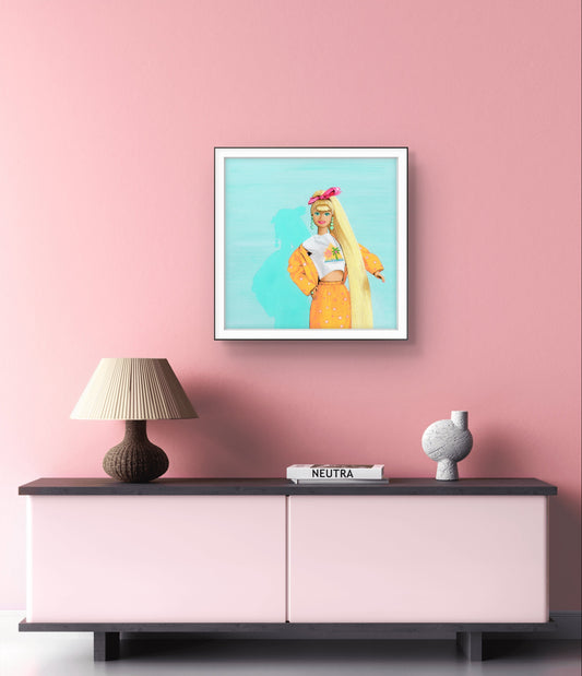 Framed artwork of a woman with long blonde hair on a pink wall above a sideboard.