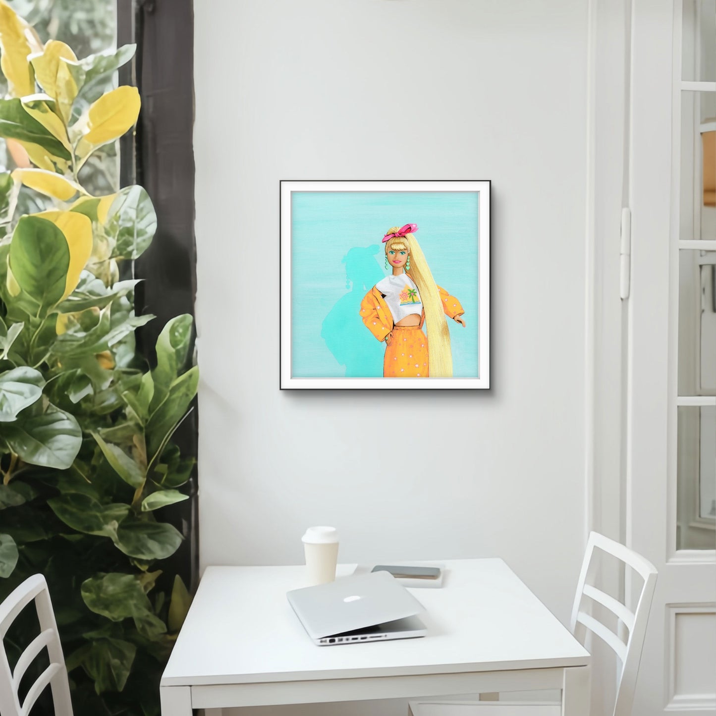 Framed artwork of a person with long blonde hair on a wall above a desk.